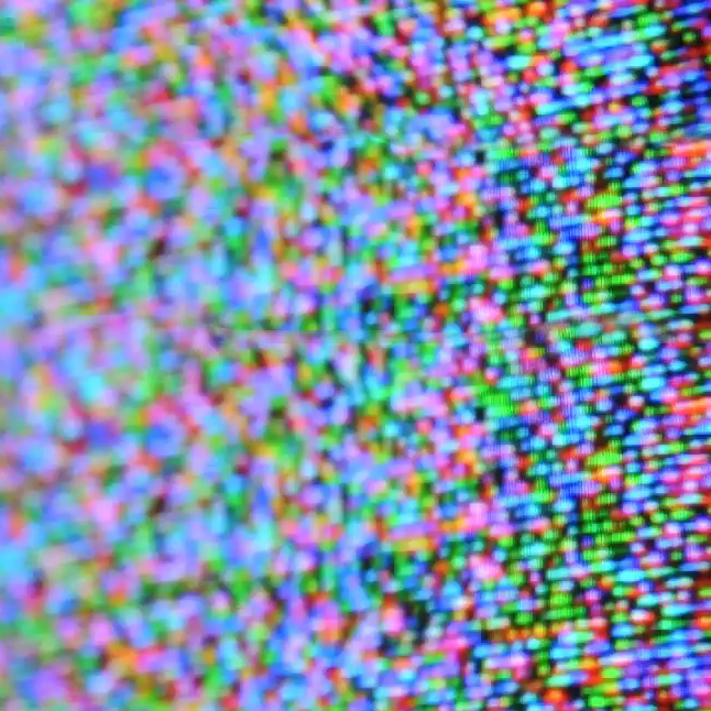 A close-up of a colour television screen showing individual pixels